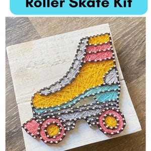 May include: A string art kit featuring a yellow roller skate with pink, blue, and black details. The kit includes all the necessary materials to create the artwork, including string, nails, and a wooden base.