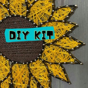 May include: A DIY kit for string art featuring a sunflower design. The sunflower is made with yellow and black string wrapped around nails hammered into a wooden board. The center of the sunflower is brown. The text "DIY KIT" is written on a turquoise background.