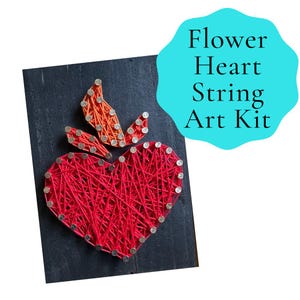 May include: A red heart-shaped string art design with orange leaf accents, mounted on a dark gray rectangular board. The design is made with red string and silver nails. The text "Flower Heart String Art Kit" is in a blue bubble.