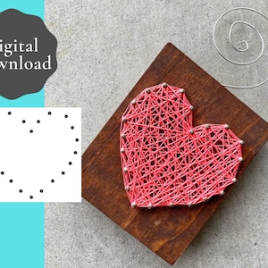 May include: A pink string art heart on a wooden base. The heart is made of string wrapped around nails hammered into the wood. The nails are arranged in the shape of a heart.