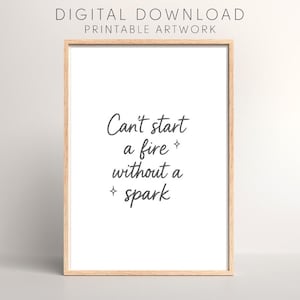 May include: A framed print with the text "Can't start a fire without a spark" in a handwritten style. The print is in a light wood frame and includes the words "DIGITAL DOWNLOAD PRINTABLE ARTWORK" at the top.