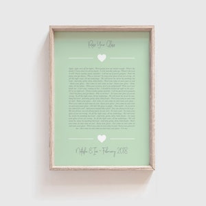 May include: A light green printable art print with a white heart and the text "Raise Your Glass" in a white font. The text continues with a song lyric about raising a glass to celebrate. The print also includes the text "Natasha & Ian - February 2018".