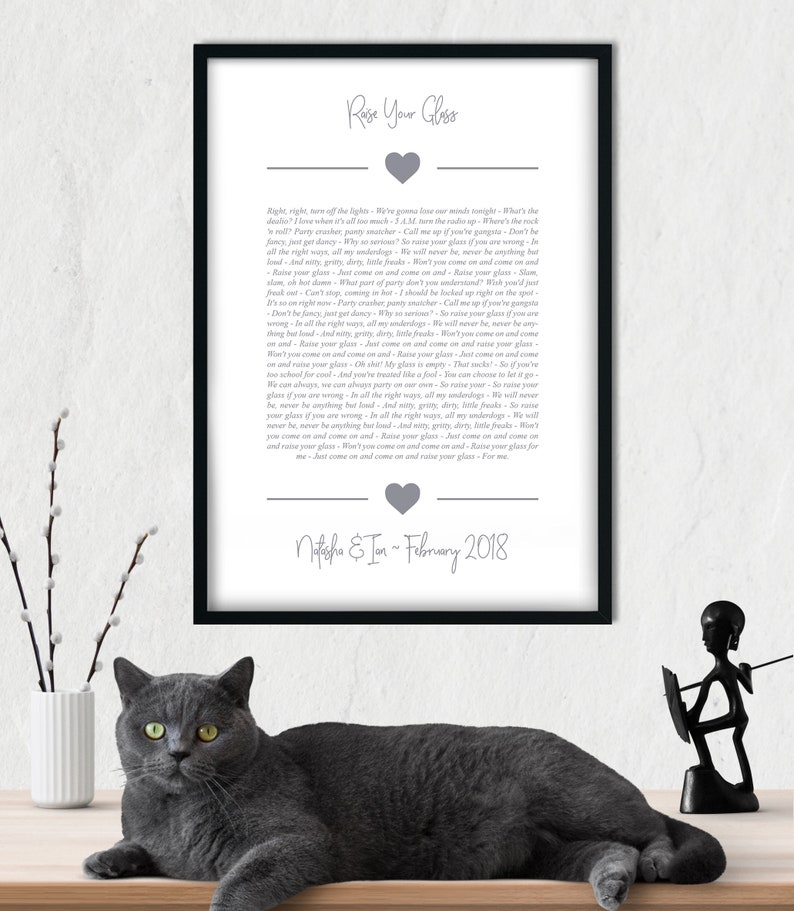 May include: A printable wedding sign with a gray heart and the text "Raise Your Glass" in a gray font. The text below the heart reads "Right, right, turn off the lights... We're gonna lose our minds tonight... That's the dealio. I love when it's all too much - 3 A.M. now, the radio's rockin'... Party crasher, pry the mic... Call me up if you've got a problem... Don't be fancy, just get dancy. Why so serious? So raise your glass if you are wrong... In all the right ways, all my underdogs, we'll never be, never be anything but loud... And gritty, dirty, little freaks... So raise your glass... Just come on and come on and raise your glass... Slam, slam, oh, boy, damn. What part of party don't you understand? Wish you'd freak out. Can't stop coming in hot. I should be locked up right on the spot... Don't be fancy, just get dancy. Why so serious? So raise your glass if you are wrong... In all the right ways, all my underdogs, we'll never be, never be anything but loud... And gritty, dirty, little freaks... Just come on and come on and raise your glass... Oh, my glass is empty. That sucks... So if you're too cool for school... And you've treated me like a fool... You can choose to let it go... We can have, we can always party on our own... So raise your glass... So raise your glass if you are wrong... In all the right ways, all my underdogs, we'll never be, never be anything but loud... And gritty, dirty, little freaks... So raise your glass... Just come on and come on and raise your glass... Won't you come on and come on and raise your glass... Just come on and come on and raise your glass... For me... Natasha & Ian - February 2018"