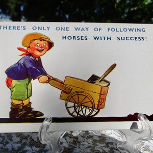 May include: A vintage postcard with a cartoon illustration of a boy pushing a wheelbarrow with the text "There's only one way of following horses with success!"