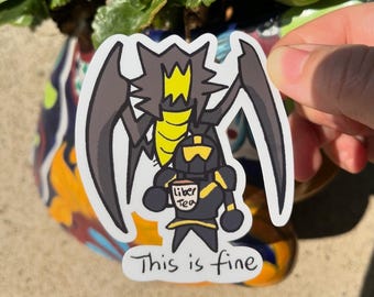Puede incluir: Una pegatina negra y amarilla con un caballero de dibujos animados sosteniendo una taza de té. El caballero lleva armadura y una corona en la cabeza. La pegatina dice "This is fine" y "Liber Tea" en la taza.