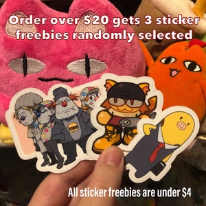 May include: Five colorful cartoon character stickers. The stickers are on a pink and orange plush toy background. The text "Order over $20 gets 3 sticker freebies randomly selected" is at the top of the image. The text "All sticker freebies are under $4" is at the bottom of the image.