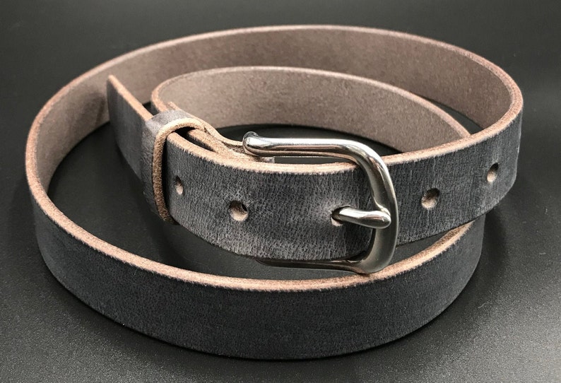 Full Grain Genuine Leather Belt in Gray Color with Silver Buckle. The edges are finished and dyed to match the main leather color. The buckle is buckle and the tail place through the keeper. Chicago Screws hold the buckle onto the leather strap.