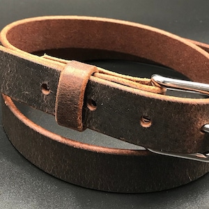 Full Grain Genuine Leather Belt in Distressed Color with Silver Buckle. The edges are finished and dyed to match the main leather color. The buckle is buckle and the tail place through the keeper. Chicago Screws hold buckle onto the leather strap.