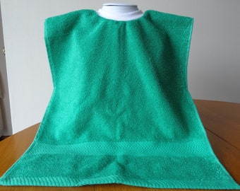 May include: A bright green terry cloth bib with a white trim around the neck.