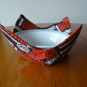 Cleveland Browns bowl cozy holding a white bowl.