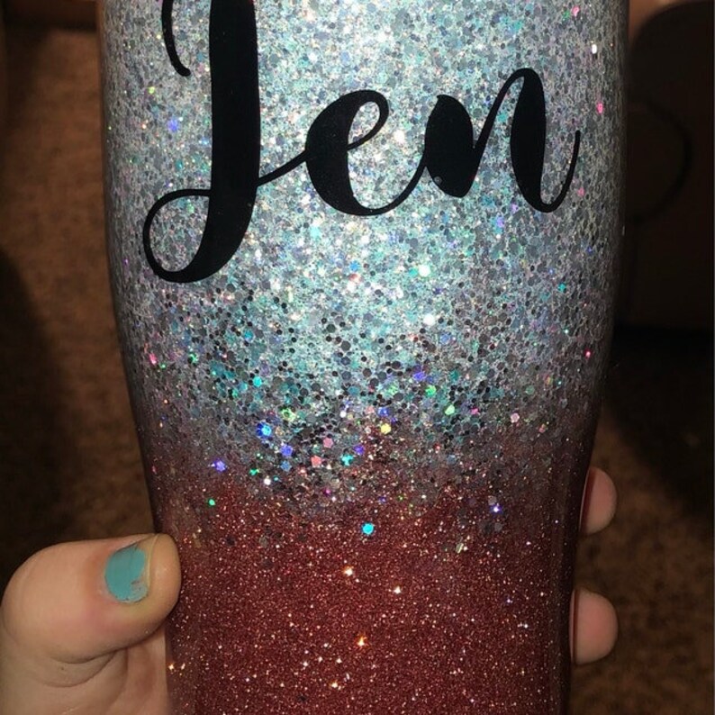 May include: A silver and red glitter tumbler with the name "Jen" in black lettering.