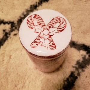 May include: White jar with a red and white candy cane design on the lid.