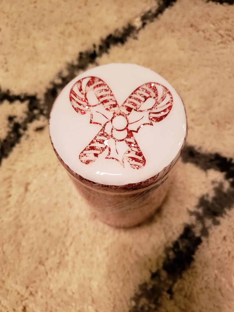 May include: White jar with a red and white candy cane design on the lid.