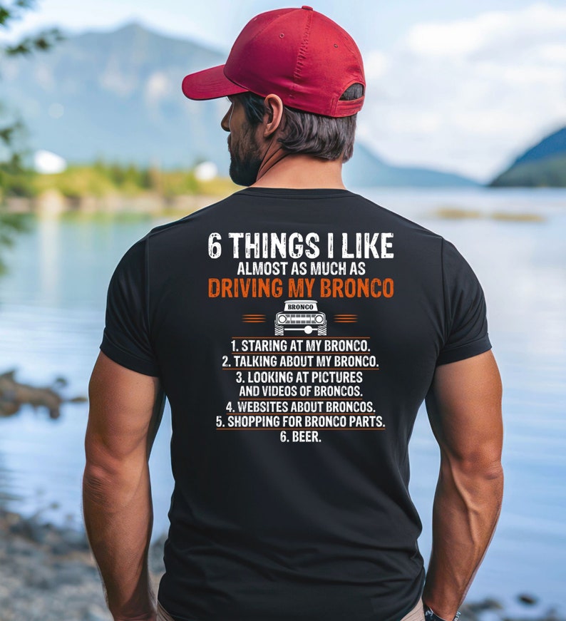 May include: A black t-shirt with a white graphic that says "6 Things I Like Almost As Much As Driving My Bronco". The graphic also includes a small image of a Ford Bronco.