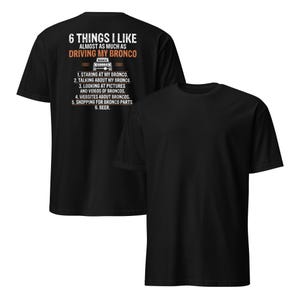 May include: Black t-shirt with white text that reads "6 Things I Like Almost As Much As Driving My Bronco." The text lists six things, including "staring at my Bronco", "talking about my Bronco", and "beer".