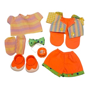 May include: A colorful clown costume set featuring a striped shirt, shorts, vest, socks, shoes, bow tie, and a small toy. The outfit includes orange, yellow, green, and blue accents.