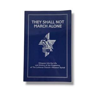May include: A navy blue book with the title "THEY SHALL NOT MARCH ALONE" in silver lettering. The cover features a silver emblem of a cross, eagle, and shield. The text "Glimpses into the Life and History of the Chaplaincy of The Lutheran Church-Missouri Synod" is also present.