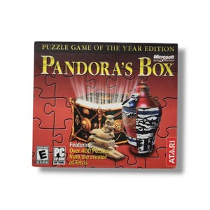 May include: A red box with the text "Puzzle Game of the Year Edition" and "Pandora's Box" in gold lettering. The box features a Microsoft game studios logo and an Atari logo. The box shows a red and gold treasure chest with a golden keyhole and a red and white patterned vase.