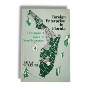 May include: A book cover with a map of Florida showing the impact of non-U.S. direct investment. The title is "Foreign Enterprise in Florida: The Impact of Non-U.S. Direct Investment" by Mira Wilkins.