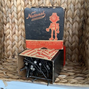 May include: A box of black nails with a red and black box featuring a cartoon robot with the text "National Products" and "The National Screw & Mfg. Company Cleveland, Ohio Los Angeles, Calif. Made in U.S.A."