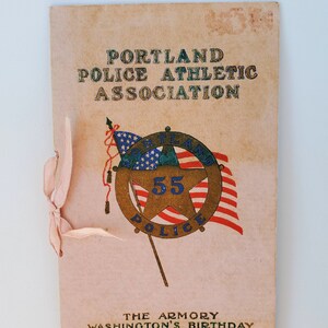 May include: A vintage program for the Portland Police Athletic Association's Washington's Birthday event, held at The Armory on February 22, 1913. The program features a gold star with the number 55 and the words "Portland Police" in a circle.