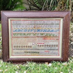 Dated 1870 Antique Needlepoint Sampler By Anna W - Framed In Antique Oak Frame - Flower Design - Colorful Geometric Borders - Early Textile