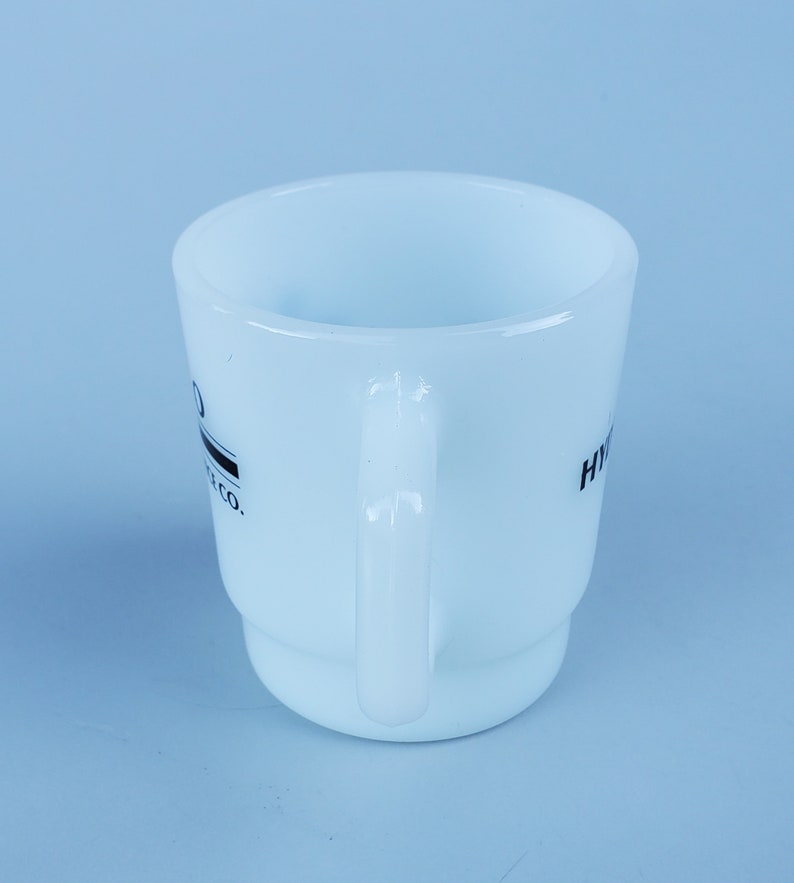 May include: White ceramic mug with a black logo that reads "Hydro Flask Co.".