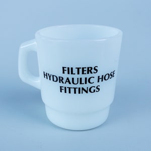 May include: White ceramic mug with black text that reads "FILTERS HYDRAULIC HOSE FITTINGS".