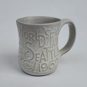 1962 Seattle Worlds Fair Century 21 Coffee Mug - Made By Pacific Stoneware - Space Needle Design - White Matt Glaze - Nice Detail - 4&quot;