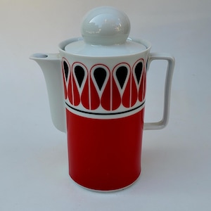 May include: A vintage ceramic coffee pot with a white spout, handle, and lid. The cylindrical body is red with a black and red teardrop pattern. The lid has a white sphere-shaped knob. A classic piece for serving coffee or tea.