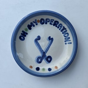 M A Hadley Hand Decorated Sympathy Plate - Oh My Operation Lettering - Stethoscope Design - Blue Border - Signed M A Hadley Mark - 4.25"
