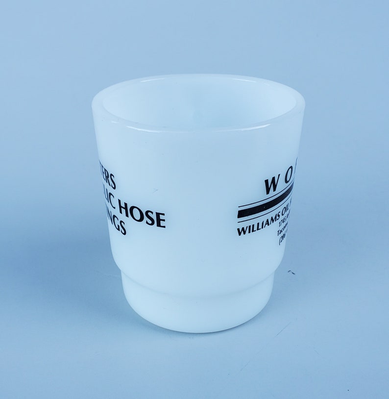 May include: White ceramic mug with black text that reads "Peters Hydraulic Hose Fittings" and "Williams Oil-O-Matic Factory Branch (208) 342-7777".