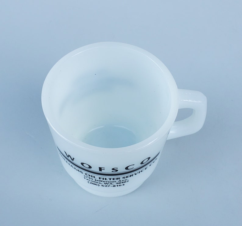 May include: White ceramic mug with a black logo that reads "Wofsco Oil Filter Service Co. 1741 Jefferson Ave. Tacoma, WA. 98402 (206) 627-8163"