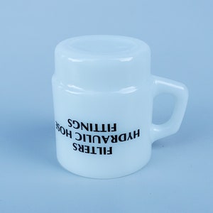 May include: White ceramic mug with black text that reads "FILTERS HYDRAULIC HOSE FITTINGS".