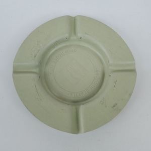 May include: A light green ceramic ashtray with a white logo that reads "Seattle, Kenworth, Open House 1963".