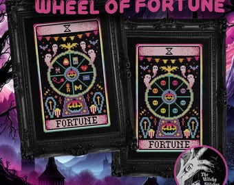 May include: Two framed cross-stitch patterns titled WHEEL OF FORTUNE, featuring a central Ferris wheel design with ghosts, bats, and pumpkins on a black background. The artwork is encased in ornate black frames with a pink and purple color palette.