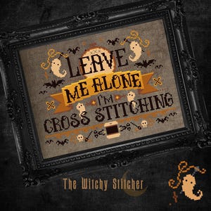 May include: A cross stitch pattern with a brown background and orange, yellow, and white text that reads "Leave me alone I'm cross stitching". The pattern is surrounded by small black bats and ghosts.