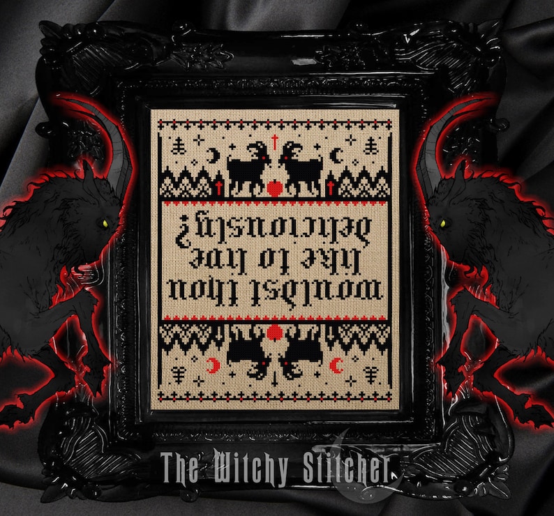 May include: A framed cross-stitch piece with a black frame. The cross-stitch features black goats, moons, and the text "Wouldst thou like to live deliciously?" in red and black. The words "The Witchy Stitcher" are at the bottom.