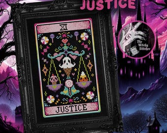 May include: A framed cross-stitch pattern titled JUSTICE featuring a central ghost holding scales balanced with a skull and candy corn. The design includes colorful sweets, hearts, and geometric motifs on a black background, all encased in an ornate black frame.