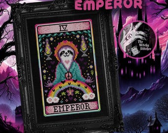 May include: A cross-stitch embroidery of a sloth depicted as a tarot card titled EMPEROR, featuring a rainbow, a peace sign, and a halo, framed in a black ornate frame. The design includes the Roman numeral IV and small heart motifs.