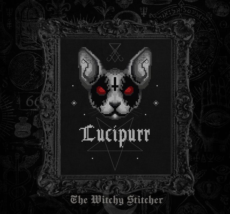 May include: A cross-stitch pattern featuring a stylized cat head with red eyes, black markings, and an inverted cross on the forehead. Below the cat is the text Lucipurr above a pentagram. The bottom text reads The Witchy Stitcher.