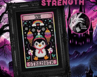 May include: A cross-stitch art piece in a black ornate frame featuring a penguin wearing a party hat, holding two ice cream cones, with a rainbow and the text STRENGTH. The design includes candy, birds, and the Roman numeral VIII.