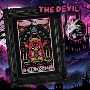 May include: Framed cross-stitch art featuring "The Devil" tarot card. The artwork showcases a colorful, pixelated devil figure with a black background, framed in a black ornate frame. The text "THE DEVIL" is displayed at the top and bottom of the image.