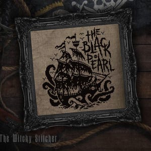 May include: A cross-stitch embroidery featuring a black ship and a giant octopus on tan fabric, framed in an ornate black frame. The text reads THE BLACK PEARL, accompanied by small bird silhouettes and a skull icon on the ship's hull.