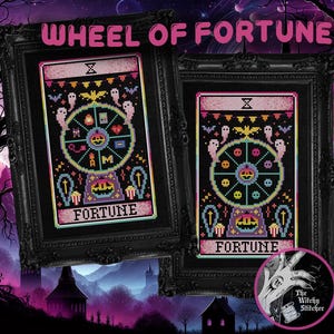 May include: Two framed cross-stitch artworks featuring a tarot card design with a Halloween theme. The artwork includes a wheel with spooky symbols, ghosts, and the word "FORTUNE". The phrase "WHEEL OF FORTUNE" is at the top.