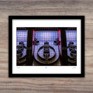 May include: A framed print of a vintage Skee-Ball game. The game features a series of numbered targets and a ramp for rolling balls. The print includes the text "FRAMES NOT INCLUDED".