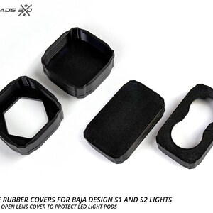 May include: Black protective rubber covers for Baja Design S1 and S2 lights. The image shows four black covers, including full and open lens covers, designed to protect LED light pods. The text on the image says "Protective rubber covers for Baja Design S1 and S2 lights."