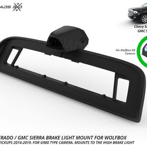May include: A black plastic brake light mount for Chevy Silverado 2014-2018 and GMC Sierra 2014-2019 trucks. The mount is designed for a Wolfbox G9 camera and attaches to the high brake light. Includes text: CROSSROADS 360, CHEVY SILVERADO / GMC SIERRA.