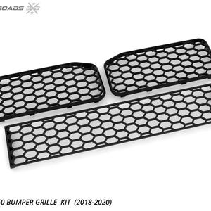 May include: A black Ford F150 bumper grille kit, featuring a honeycomb pattern. The kit includes three pieces: two rectangular grilles and one longer, rectangular grille. The text "FORD F150 BUMPER GRILLE KIT (2018-2020)" is visible.