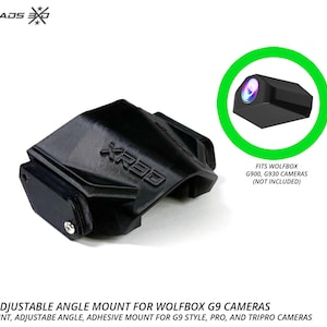 Op de afbeelding: Een zwarte, compacte houder met verstelbare hoek voor Wolfbox G900 en G930 camera's. De houder is voorzien van de in reliëf aangebrachte tekst XR30 en bevat een kleine metalen schroef. Een groene cirkel markeert de cameralens en tekst geeft compatibiliteit aan.